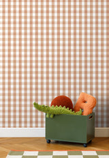 Grand Vichy wallpaper in Terracotta Doux in a children's bedroom with a toy crocodile