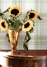 Tartan wallpaper in Vert Olive in a living room with sunflowers