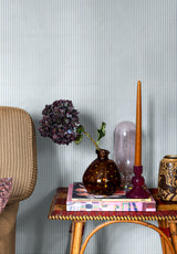 Julia Stripe wallpaper in Ciel in a bedroom with decorative objects