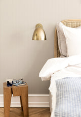 Julia Stripe wallpaper in Ecru in a bedroom