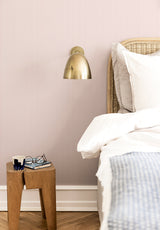 Julia Stripe wallpaper in Rose Bonbon in a bedroom