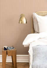 Julia Stripe wallpaper in Terracotta Doux in a bedroom